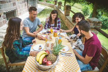 Group of friends having breakfast in a farmhouse