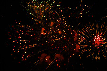 Colorful salute, great explodes in different colors in the night sky, beautifully dissolving in the air.