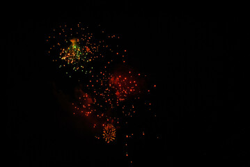 Colorful salute, great explodes in different colors in the night sky, beautifully dissolving in the air.