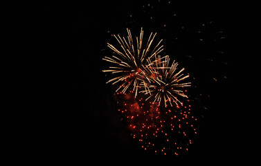 Colorful salute, great explodes in different colors in the night sky, beautifully dissolving in the air.