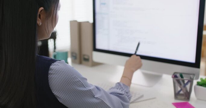 Asia young business woman sit busy at home office desk work code on desktop reskill upskill for job career remote self test IT deep tech ai design skill online html text for cyber security workforce.