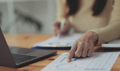 Business woman working in finance and accounting Analyze financial budget at home , Work from home concept