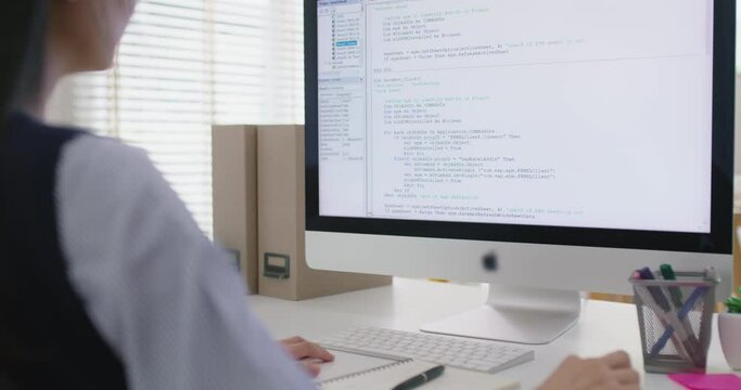 Asia young business woman sit busy at home office desk work code on desktop reskill upskill for job career remote self test IT deep tech ai design skill online html text for cyber security workforce.