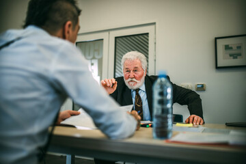 Shot of a group of business people sitting together in a meeting