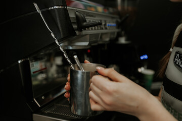 Fototapeta na wymiar The barista makes coffee on the coffee machine.