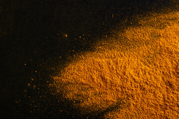 Fototapeta na wymiar Yellow color powder explosion on black background.