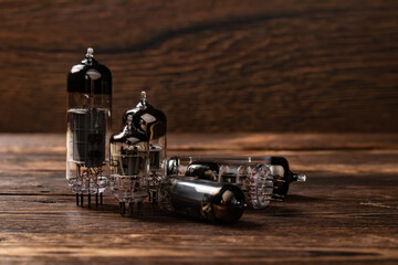 Vacuum electronic radio lamps tube on wooden background.