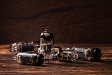 Vacuum electronic radio lamps tube on wooden background.