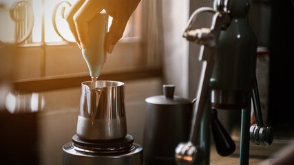Obraz na płótnie Canvas Barista preparing coffee using coffee maker and drip kettle. Man making coffee. Alternative ways of brewing coffee. Coffee shop, good quality coffee beans.