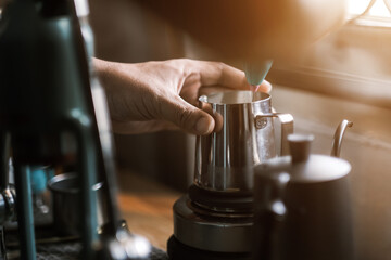 Barista preparing coffee using coffee maker and drip kettle. Man making coffee. Alternative ways of brewing coffee. Coffee shop, good quality coffee beans