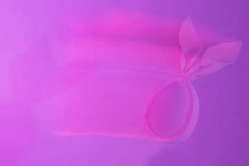Abstract frame-washed background of neon holographic purple color trek of pink egg with rabbit ears. Creative handmade concept.