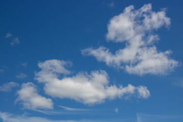 Beautiful sky background. Unusual cirrus clouds in the blue sky