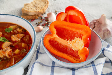 Ripe paprika and Hungarian goulash soup on the table. Traditional cuisine, national dish.
