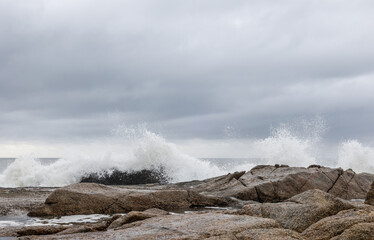 white waves splashing over rocks