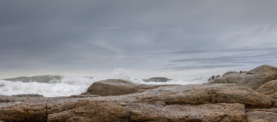 white foamy water splashing over a rock