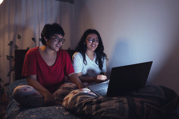 Young women at a sleepover watching movies. Enjoying the company and the good stories.