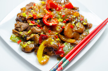 Cooked marinated beef slices with a savory black beef sauce, peppers and onions