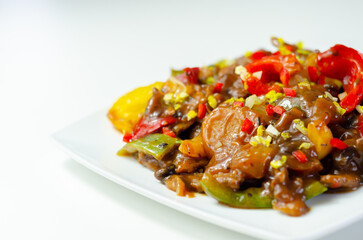 Cooked marinated beef slices with a savory black beef sauce, peppers and onions