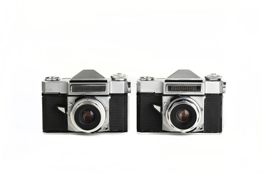 Two Very rare old 35 mm SLR film cameras on white background.