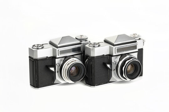 Two Very rare old 35 mm SLR film cameras on white background.