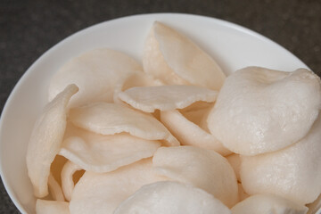 Fototapeta na wymiar Cooked rice chips in bowl - Grey background