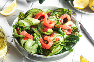 Salad with salmon, avocado, cucumber and herbs