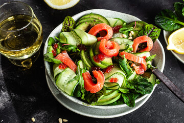 Salad with salmon, avocado, cucumber and herbs