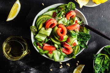 Salad with salmon, avocado, cucumber and herbs