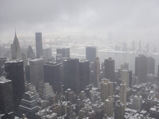 Buildings in Manhattan - NY, under clouds and snow.
