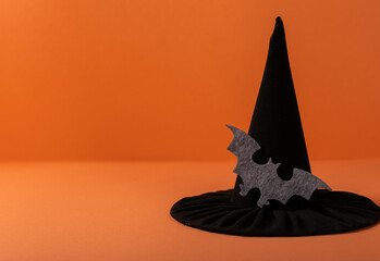 Fototapeta premium Happy Halloween holiday. Bright orange background with witch hat accessories.Halloween holiday concept.copy space