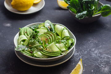 Vegetarian salad with avocado, cucumber and herbs