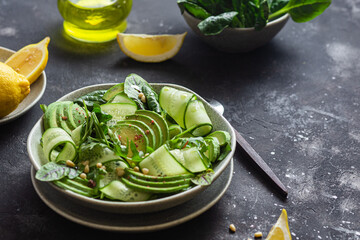 Vegetarian salad with avocado, cucumber and herbs