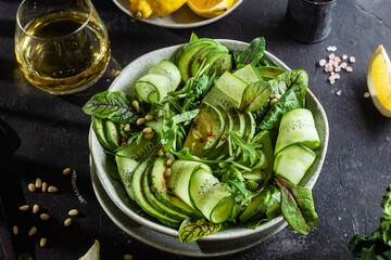 Vegetarian salad with avocado, cucumber and herbs