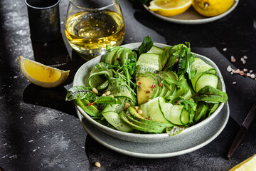 Vegetarian salad with avocado, cucumber and herbs