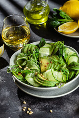 Vegetarian salad with avocado, cucumber and herbs