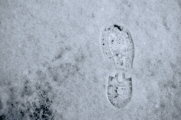 Footprint left in the snow by a man. Human footprint in the snow