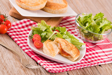 Puff pastry filled with tomato and mozzarella cheese.
