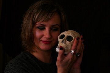 portrait of a witch woman with a skull in her hand