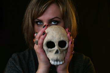 portrait of a witch woman with a skull in her hand