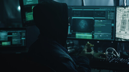 A hacker in glasses at a computer with software, during a cyber attack on the docking of the space...