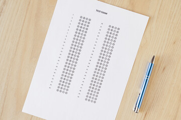 Close up and cropped examination test sheet for school / university writing answer sheets or standardized test form with answers bubbled on the table. multiple choice answer sheet. Flat lay