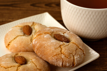 Gluten free italian cookies and a cup of tea. Almond cookies and a cup of tea. Sicilian traditional almond biscuits. Biscotti di mandorla siciliani.