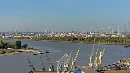 Aerial view on cranes petroleum industry infrastructure along river Scheldt in the port of antwerp