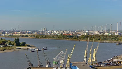 Rolgordijnen Aerial view on cranes petroleum industry infrastructure along river Scheldt in the port of antwerp © Kristof Lauwers