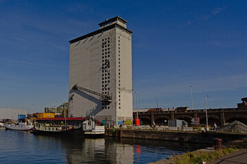 Large dock with ships in front of an abandoned industrial building in the harbor of Antwerp