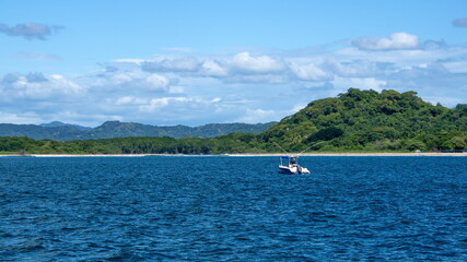 Fototapeta na wymiar Boat moored in the bay in Tamarindo, Costa Rica