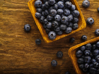 Blueberries in bowls on a wooden background. Cooking, medicine. Vitamins, antioxidants. Healthy lifestyle. Supermarket, cafe, restaurant, hotel, confectionery, culinary blog, advertising.