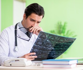 Doctor radiologist looking at x-ray scan in hospital