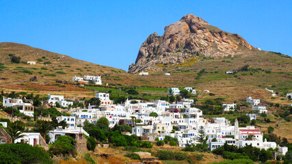 Fototapeta na wymiar On the island of Tinos, in the Cyclades, in the heart of the Aegean Sea, view of the village of Tripotamos with Mount Exobourgo in the background.