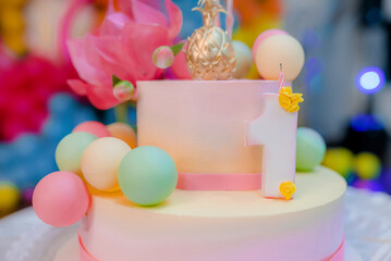 Beautiful cake with pink decor mastic for the birthday of a little girl. Candy bar. Baby birthday theme with flamingo. Festive background decoration with cake and balloons in studio.